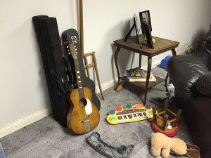 Mouse hiding place behind guitar